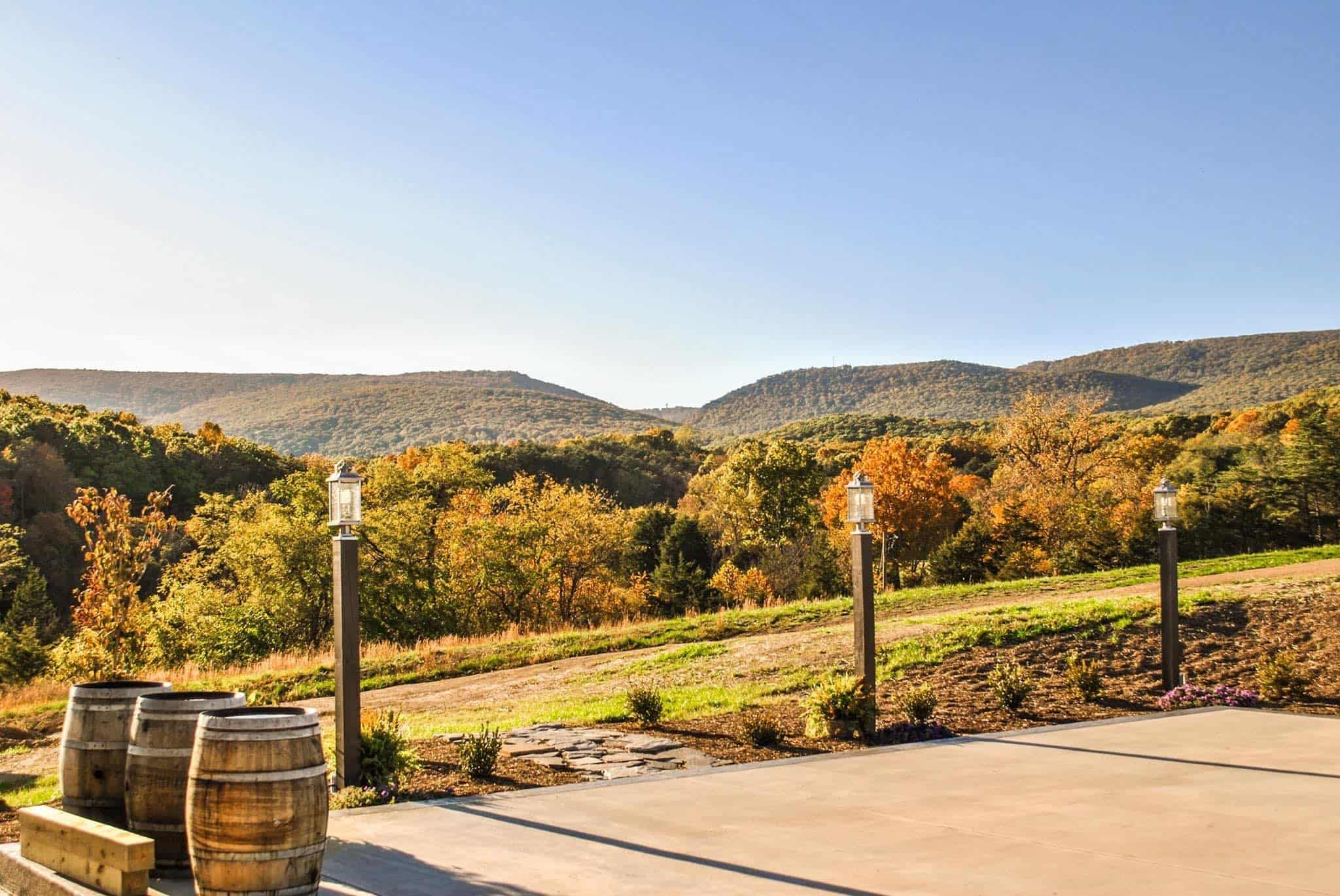 Canaan Springs barn patio decorated with whiskey barrels and vibrant fall foliage in Northern Virginia near Winchester