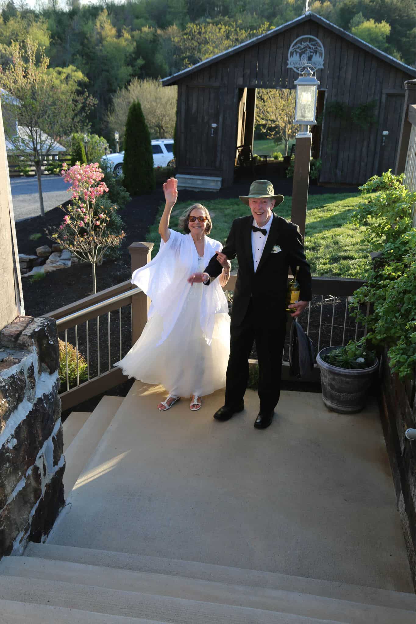 Older married couple sharing a tender goodbye moment after their wedding day with the rustic corn crib at Canaan Springs farm wedding venue in Northern Virginia