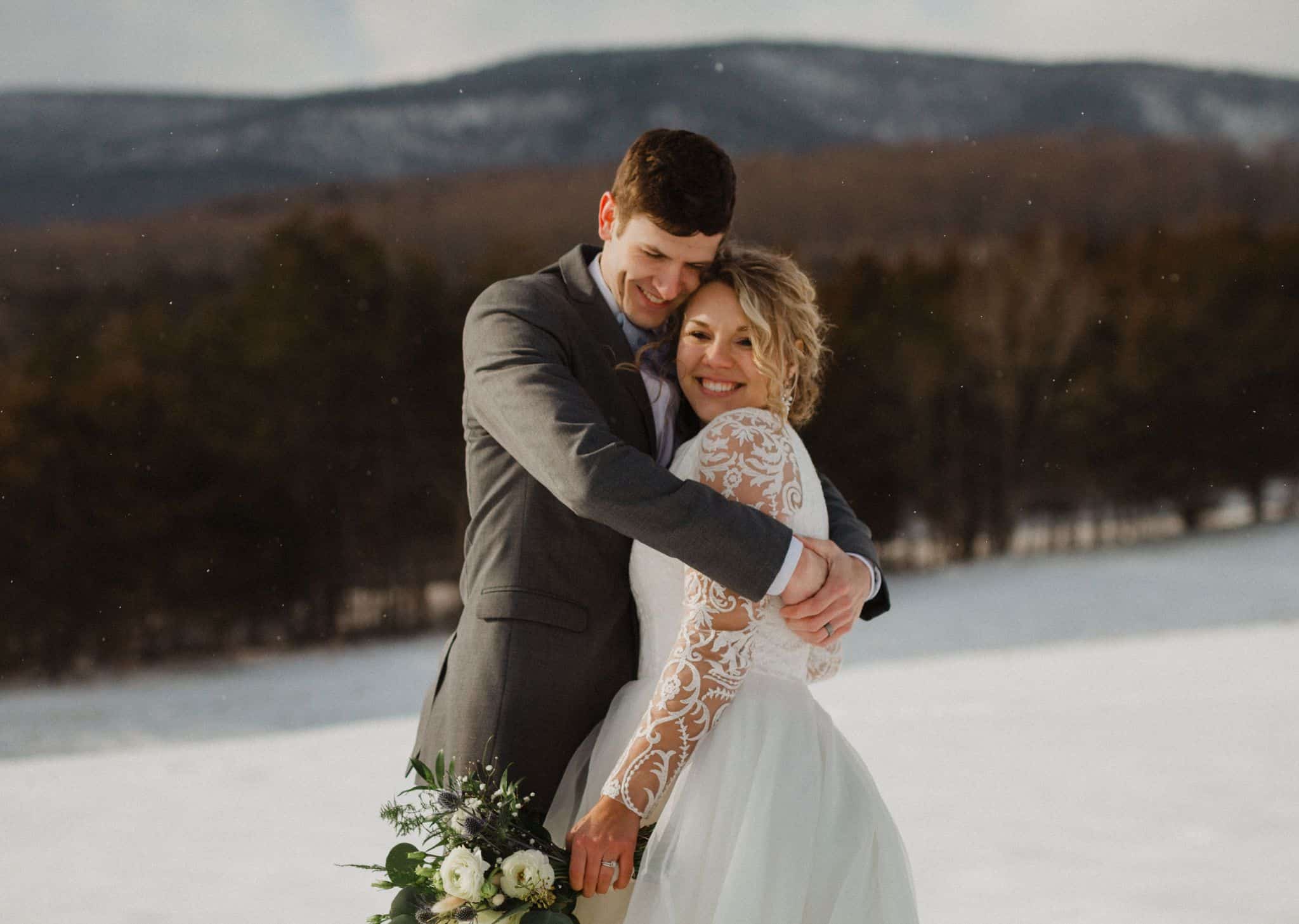 Close-up portrait of just married couple at snowy Canaan Springs during winter wedding with Blue Ridge Mountain backdrop and warm colors, a Northern VA area farm wedding venue near Winchester, VA and the Winchester area