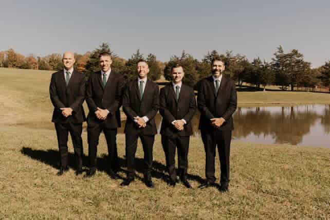 Groomsmen posed by the pond at Canaan Springs, a Northern Virginia farm wedding venue with scenic water views and natural backdrops