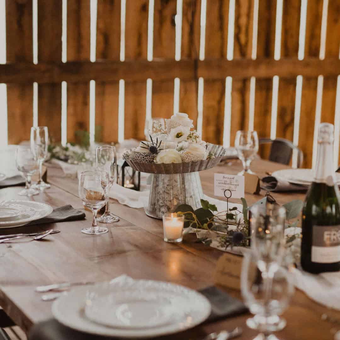 Rustic barn table setting with warm ambient lighting at Canaan Springs wedding venue in Northern Virginia near Winchester