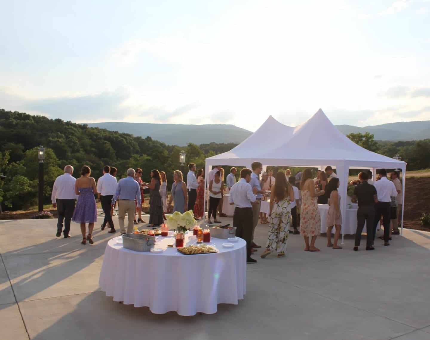 Tents set up on the barn patio at Canaan Springs for cocktail hour during a beautiful spring evening at a Northern Virginia wedding venue near Winchester