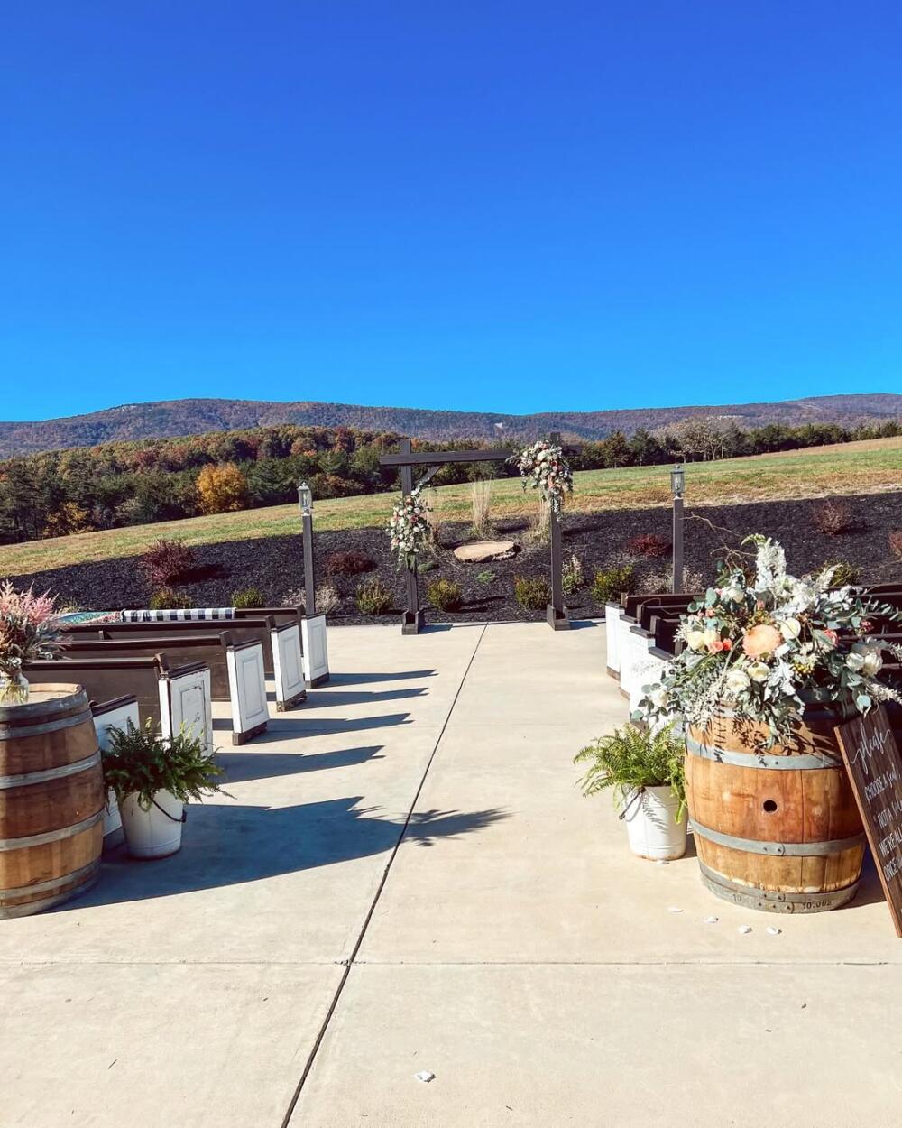 Patio Wedding Ceremony with Pews and Arbor at Canaan Springs in Northern VA Outdoor wedding ceremony on the patio at Canaan Springs in Northern VA, with vintage pews and a handmade arbor included in the venue rental.