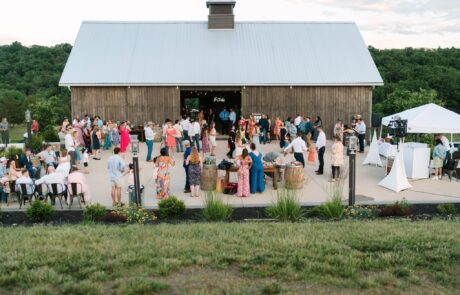 Wedding guests dancing and mingling on the spacious patio during a reception at Canaan Springs, a Northern VA wedding venue near Winchester.