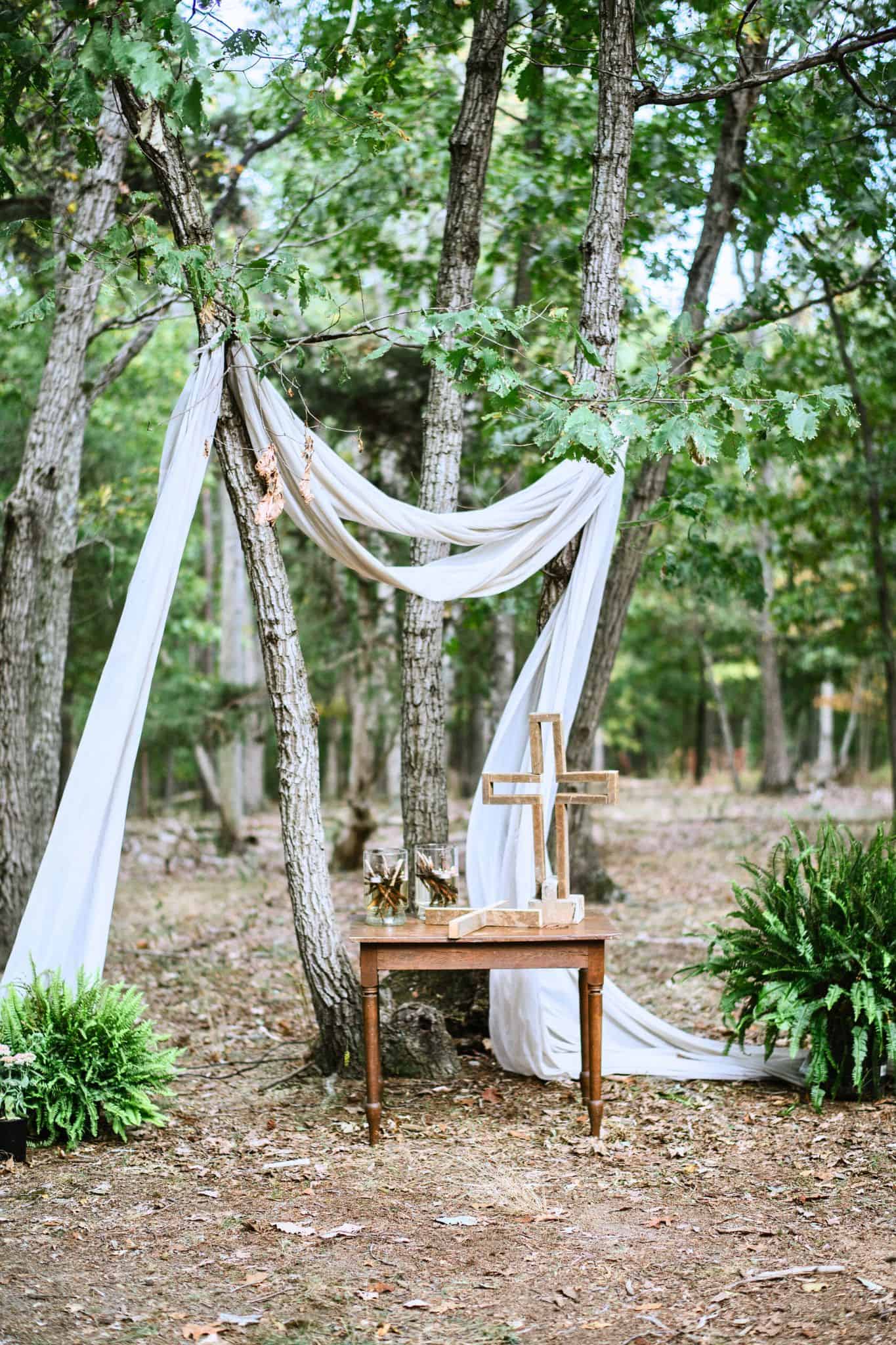 Wedding ceremony set in the woods at one of the 10 ceremony sites at Canaan Springs, featuring simple elegant décor and lush green foliage at this Northern Virginia farm wedding venue
