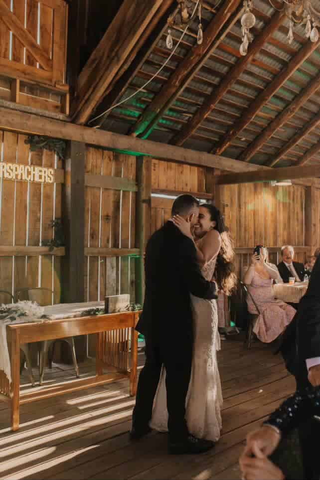 Bride and groom share their first dance in the softly lit barn at Canaan Springs, with warm ambient lighting and a romantic, intimate atmosphere at this Northern Virginia farm wedding venue