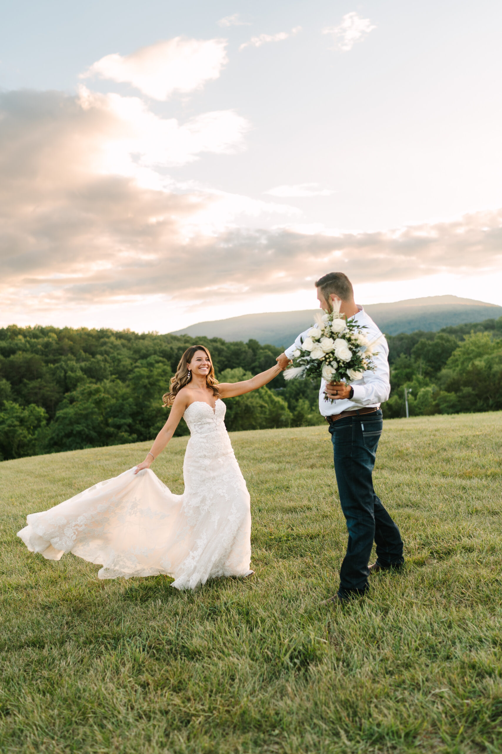Couple dancing on a hill at summer sunset with Blue Ridge Mountain views at Canaan Springs, a Northern VA wedding venue near Winchester.