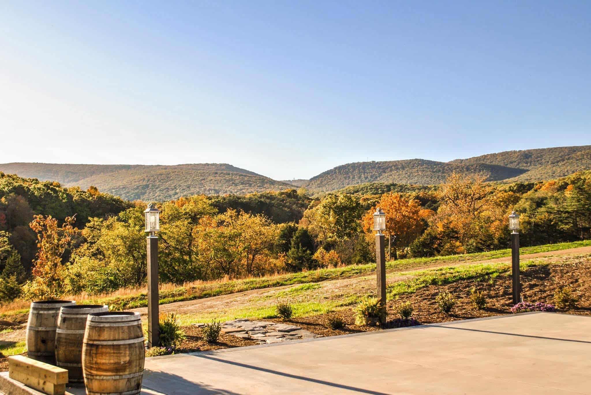 Patio at Canaan Springs wedding venue in Winchester Virginia framed by lampposts with mountain views and fall foliage