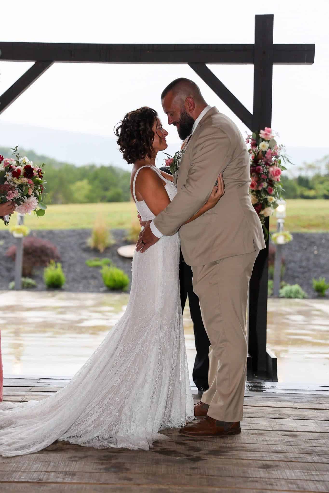 Bride and groom married inside the barn at Canaan Springs wedding venue in Winchester Virginia with scenic countryside views through the large barn doors