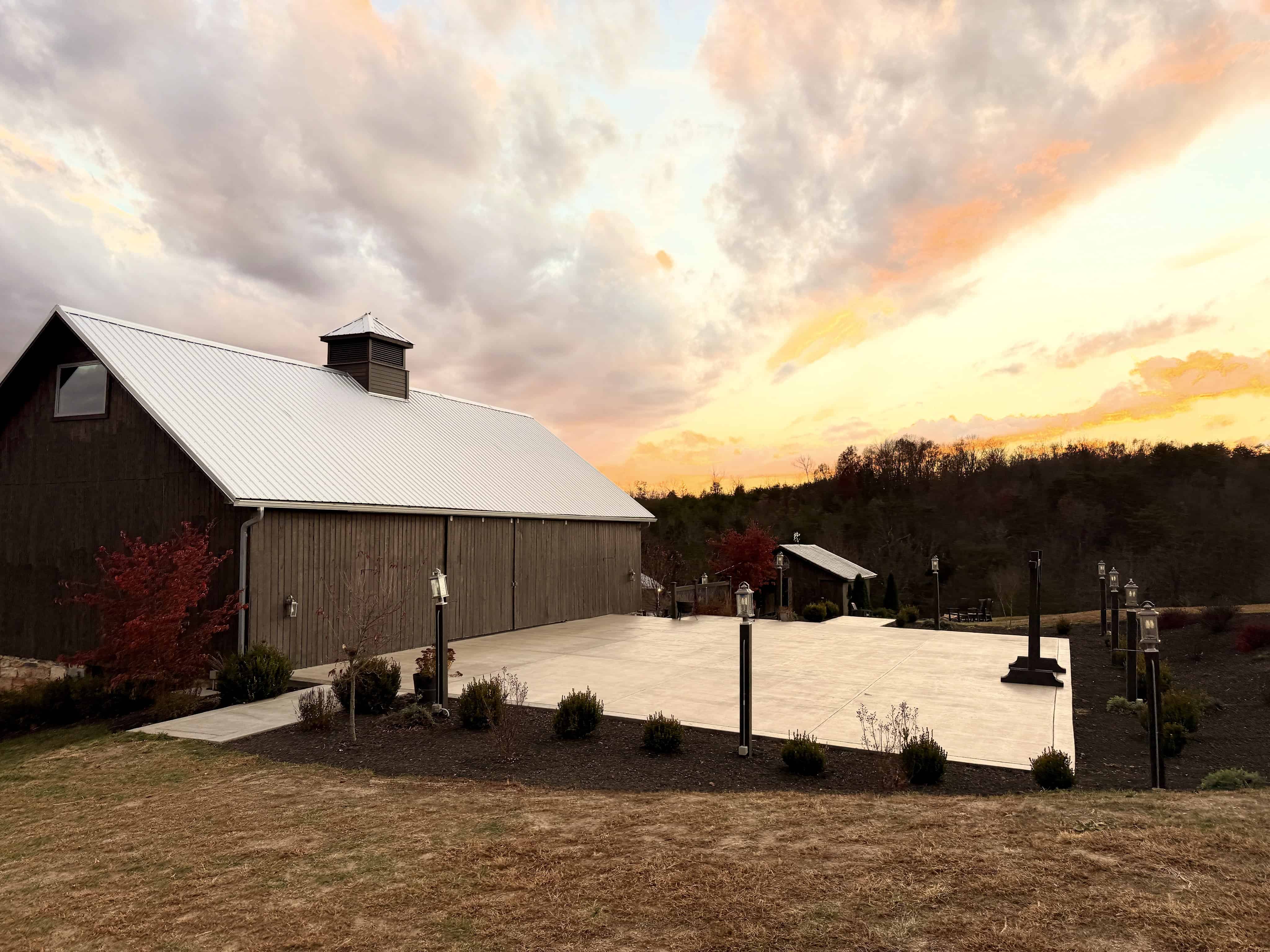 Historic barn and empty patio at sunset at Canaan Springs near Winchester, Virginia, reflecting thoughtful preservation and intentional outdoor design