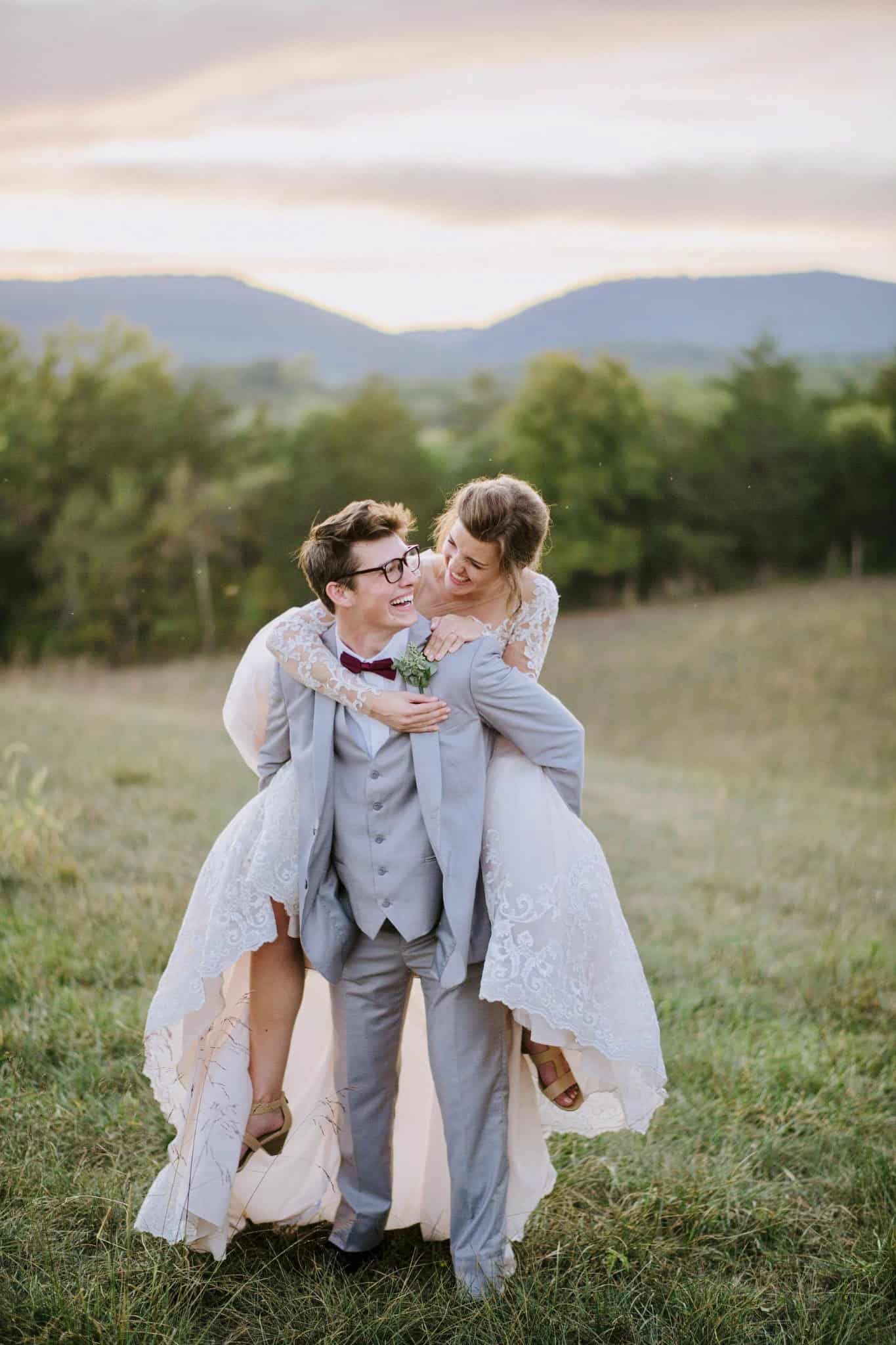 Just married couple in a lace wedding dress at sunset with Blue Ridge Mountain views at Canaan Springs in the Shenandoah Valley