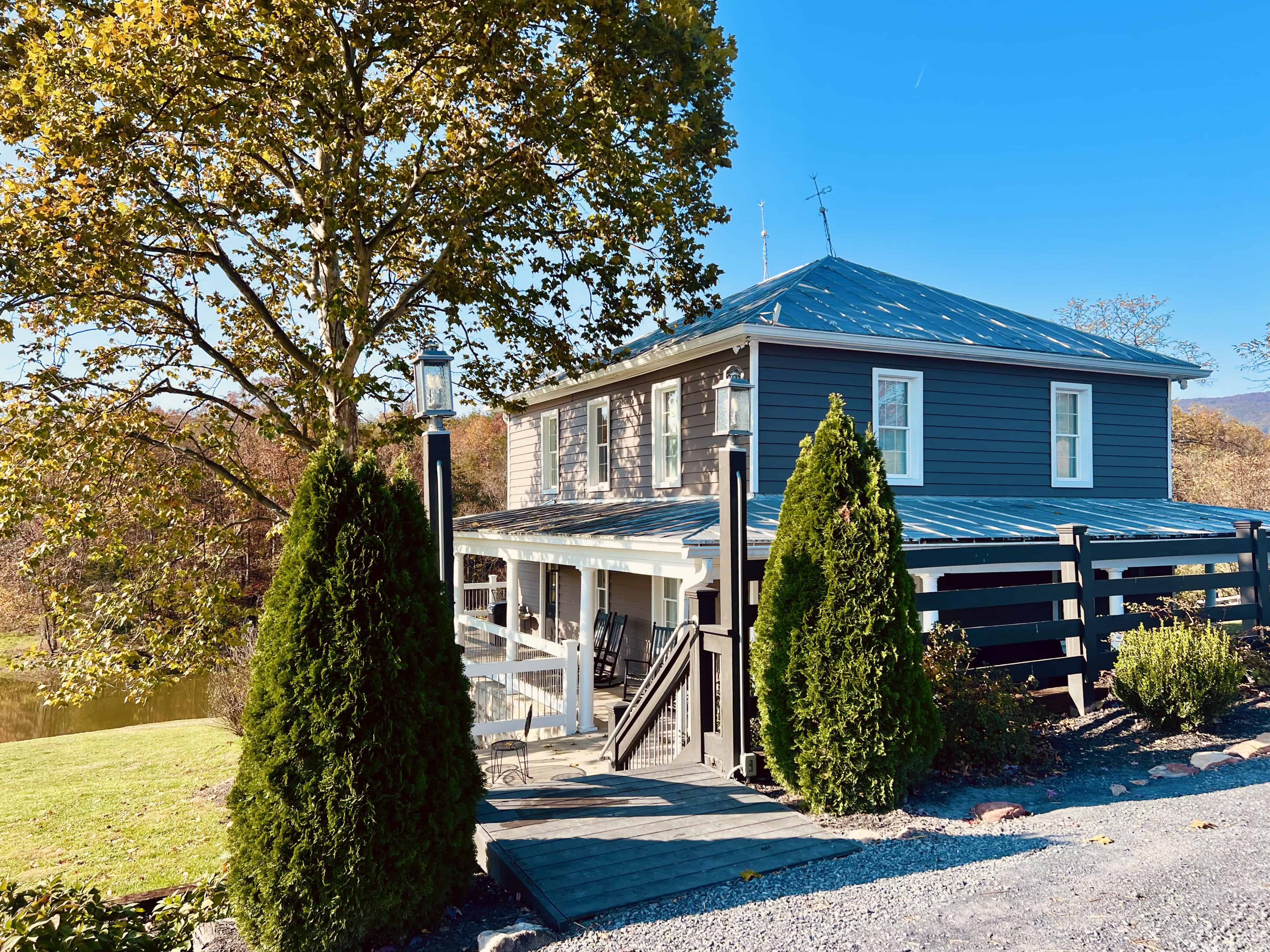 Restored farmhouse at Canaan Springs wedding venue near Winchester VA surrounded by colorful fall foliage