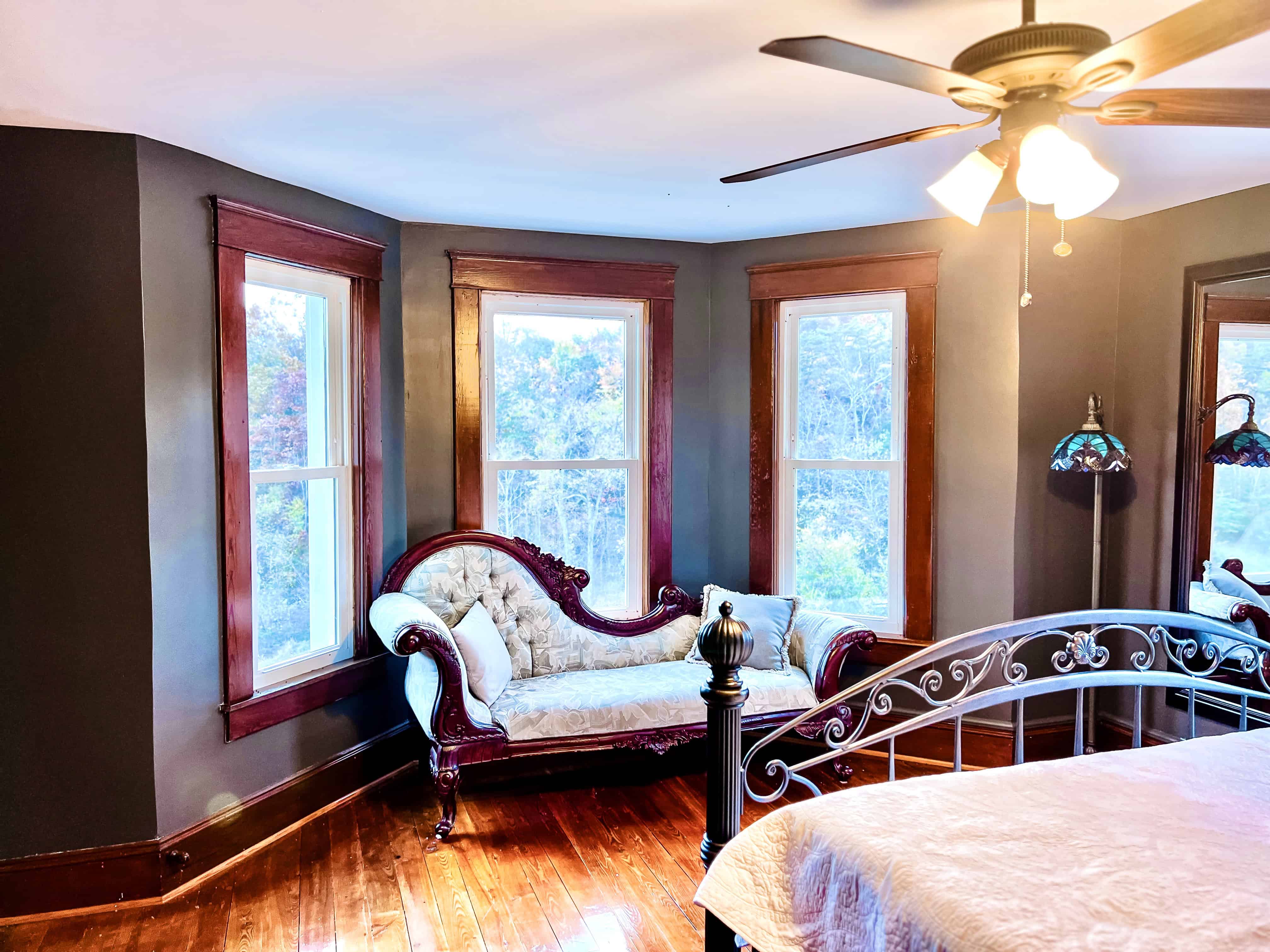 Master bedroom with elegant seating area and couch at the Canaan Springs farmhouse wedding venue in Winchester Virginia