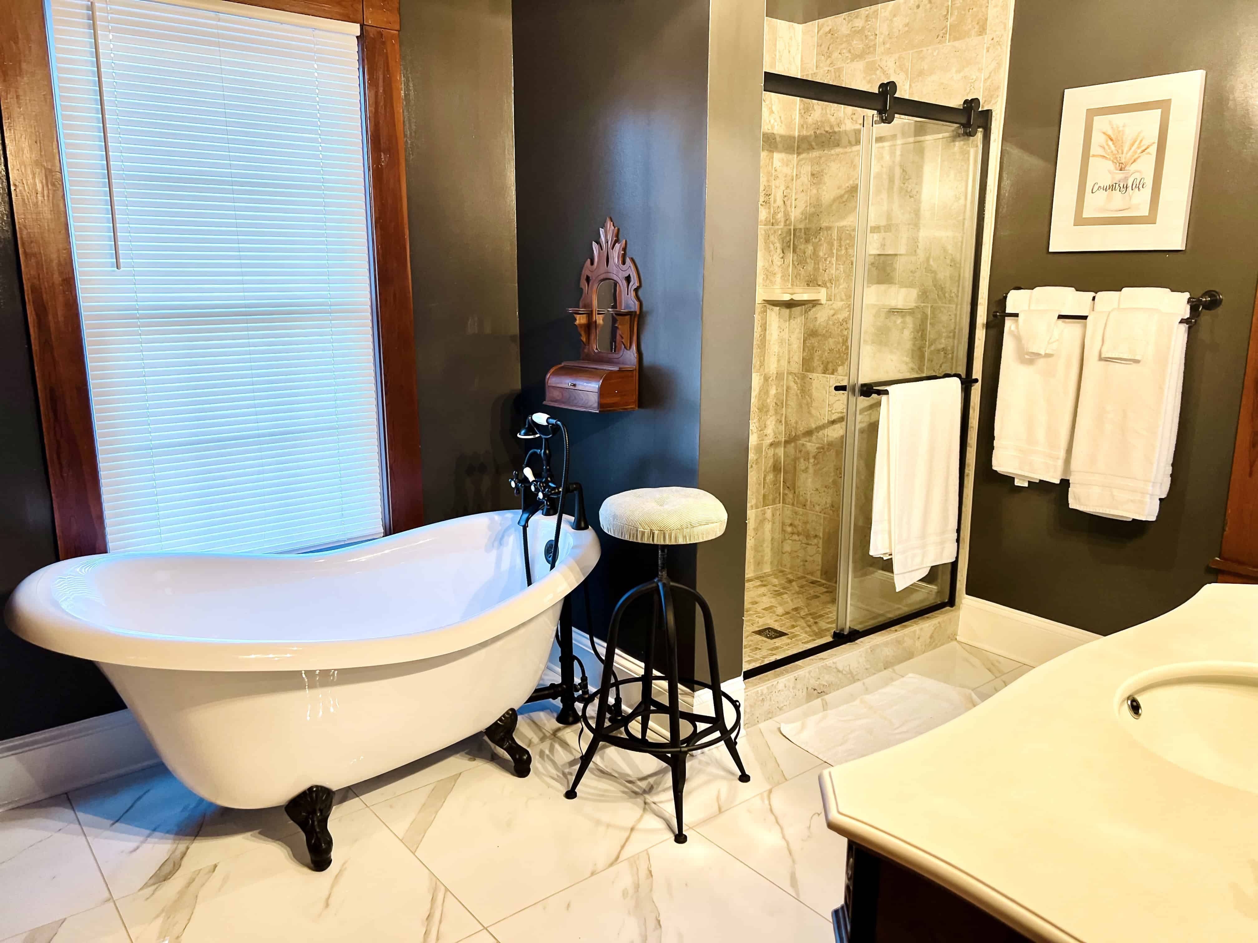 Large farmhouse bathroom with classic clawfoot tub at the Canaan Springs wedding venue in Winchester Virginia