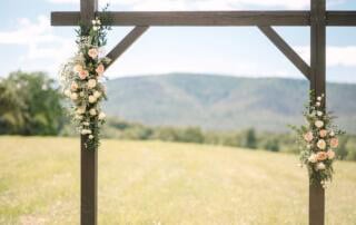 Simple wooden ceremony arbor framing Blue Ridge Mountain views at a Northern Virginia wedding venue near Winchester, Virginia