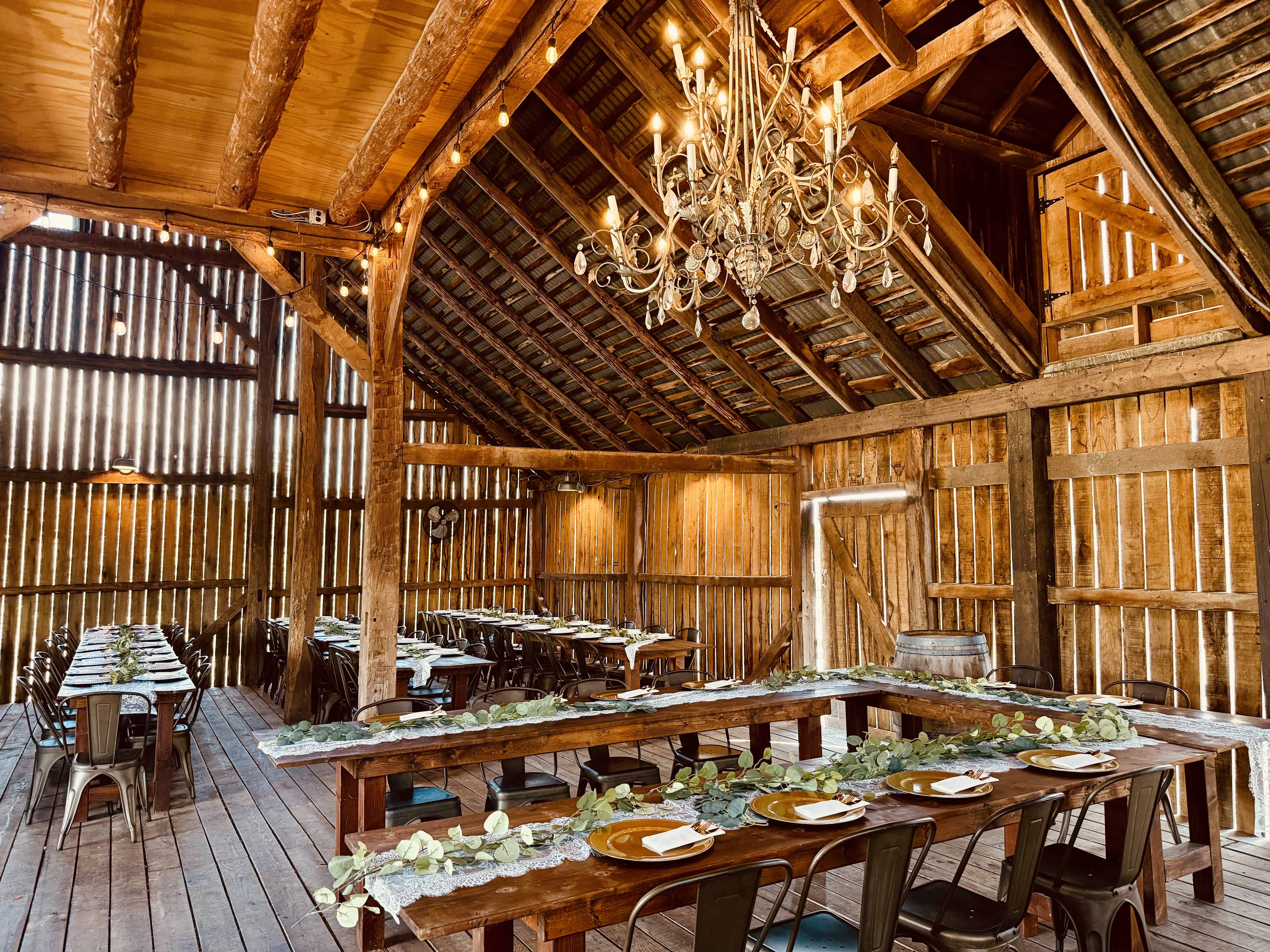Inside the historic barn at Canaan Springs with chandelier lighting, a Northern Virginia barn wedding venue near Winchester, Virginia