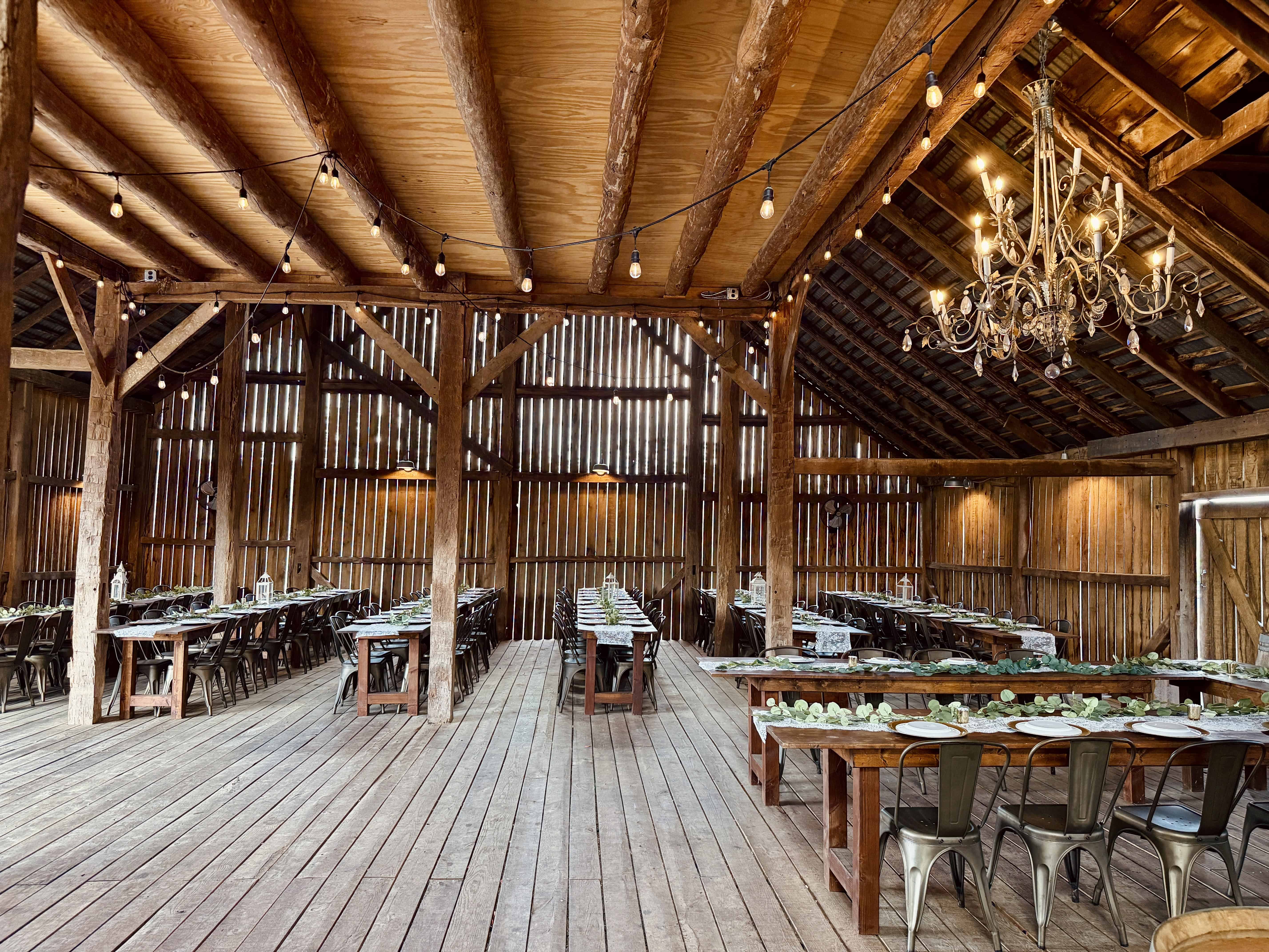 Wide open interior of the historic barn wedding venue at Canaan Springs near Winchester, Virginia, showcasing versatile event space and simple rustic beauty