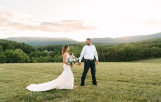 Bride and groom standing on a hilltop with sweeping mountain views at Canaan Springs, a historic Northern Virginia farm wedding venue near Winchester, VA