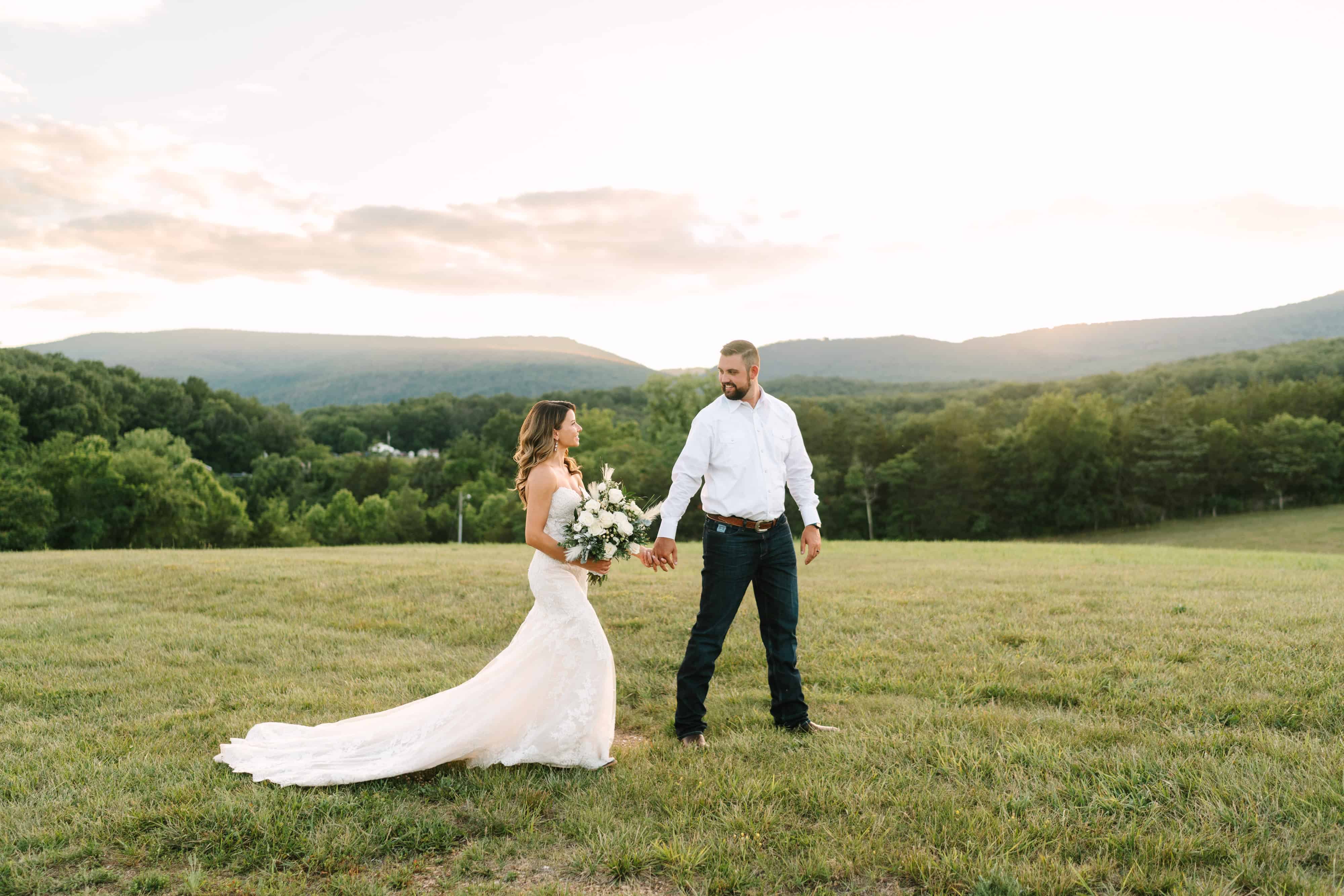 Bride and groom standing on a hilltop with sweeping mountain views at Canaan Springs, a historic Northern Virginia farm wedding venue near Winchester, VA