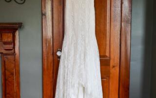 Wedding dress hanging in the master bedroom of the farmhouse at Canaan Springs, a Northern Virginia farm wedding venue near Winchester, Virginia