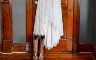 Wedding dress hanging in the master bedroom of the farmhouse at Canaan Springs, a Northern Virginia farm wedding venue near Winchester, Virginia
