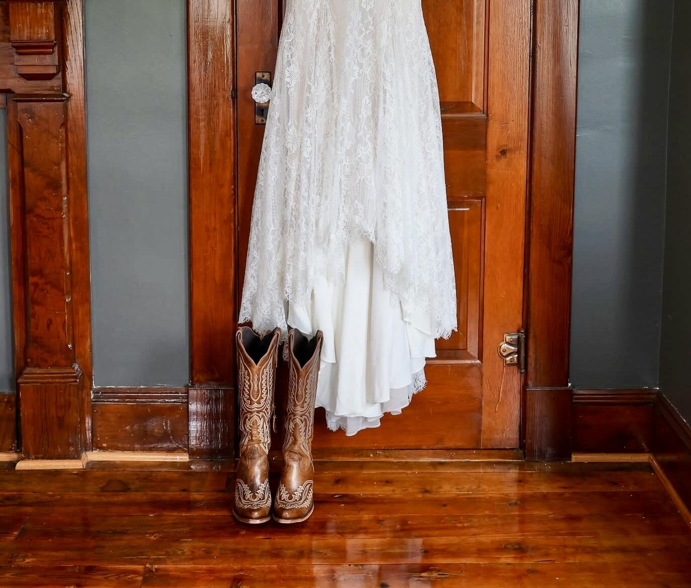 Wedding dress hanging in the master bedroom of the farmhouse at Canaan Springs, a Northern Virginia farm wedding venue near Winchester, Virginia