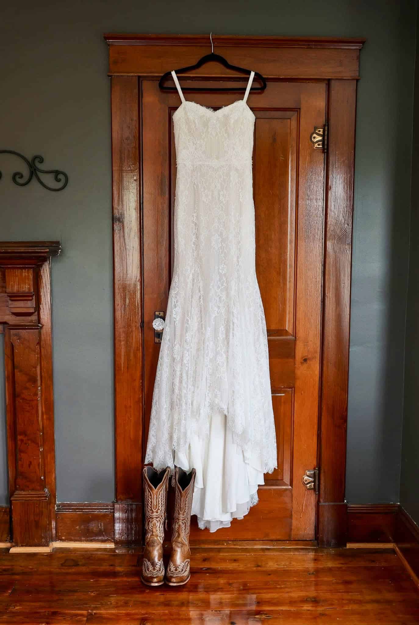Wedding dress hanging in the master bedroom of the farmhouse at Canaan Springs, a Northern Virginia farm wedding venue near Winchester, Virginia