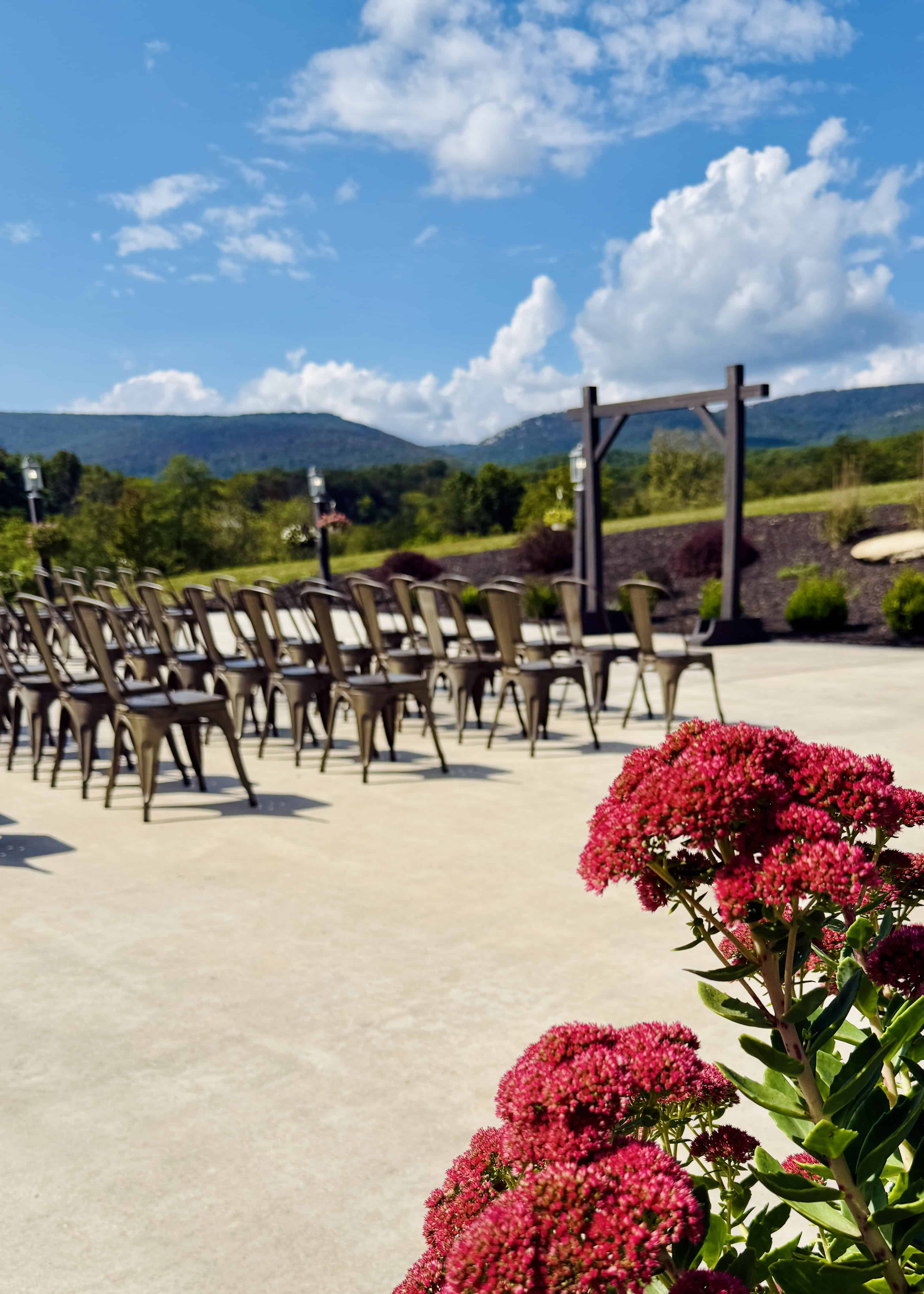 Wedding ceremony setup on the patio at Canaan Springs near Winchester, Virginia, featuring mountain views and seamless flow between indoor and outdoor spaces